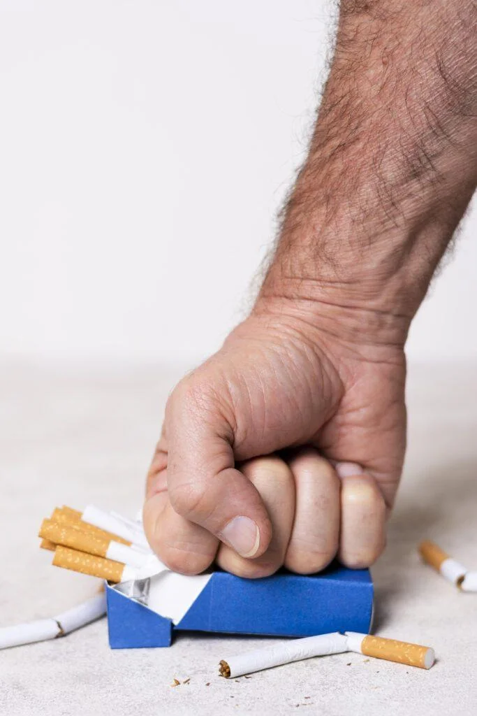 close up hand crushing cigarettes